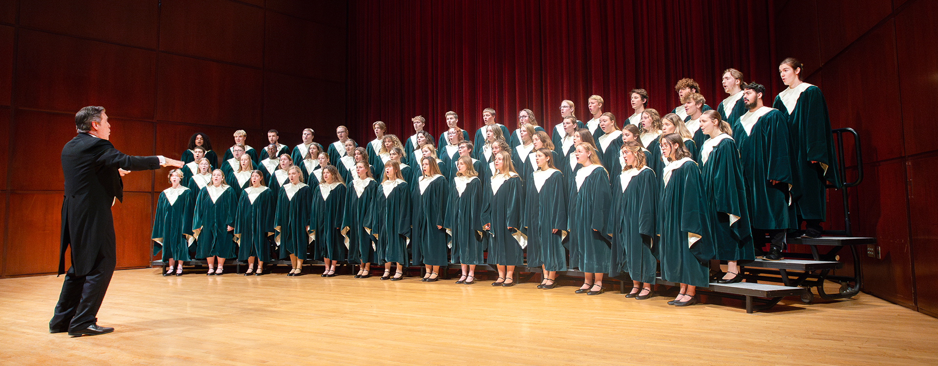 WLC students on concert hall stage for choir rehearsal